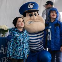 louie the laker kneeling with two boys